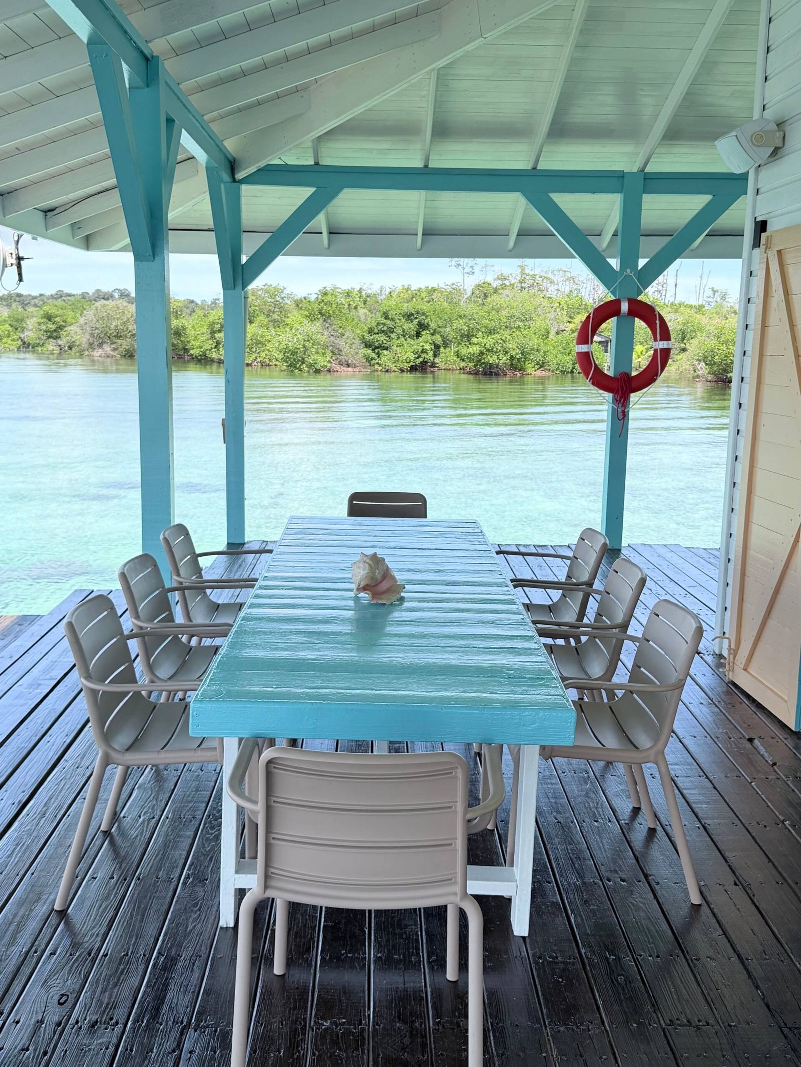 Long outdoor dining table on the covered deck at Casa Clearwater
